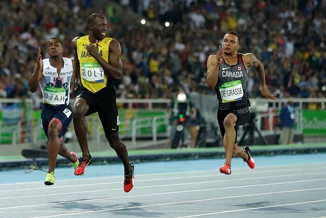 Usain Bolt (center) crosses the finish line in first place during the men's 100m final at the 2016 Rio de Janeiro Olympics. RIO DE JANEIRO=AP