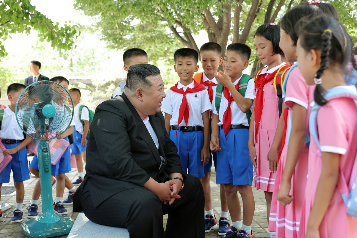 Chairman Kim talks to children in flood-stricken areas. Rodong Sinmun News 1