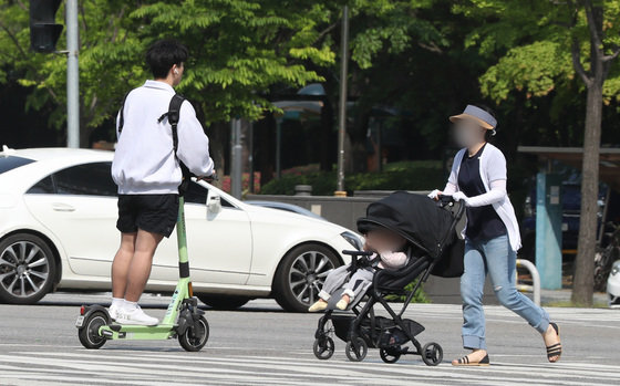 지난해 5월12일 오후 경기도 수원시의 한 거리에서 전동킥보드 이용자가 안전모를 쓰지 않고 주행을 하고 있다. 2022.5.12 뉴스1