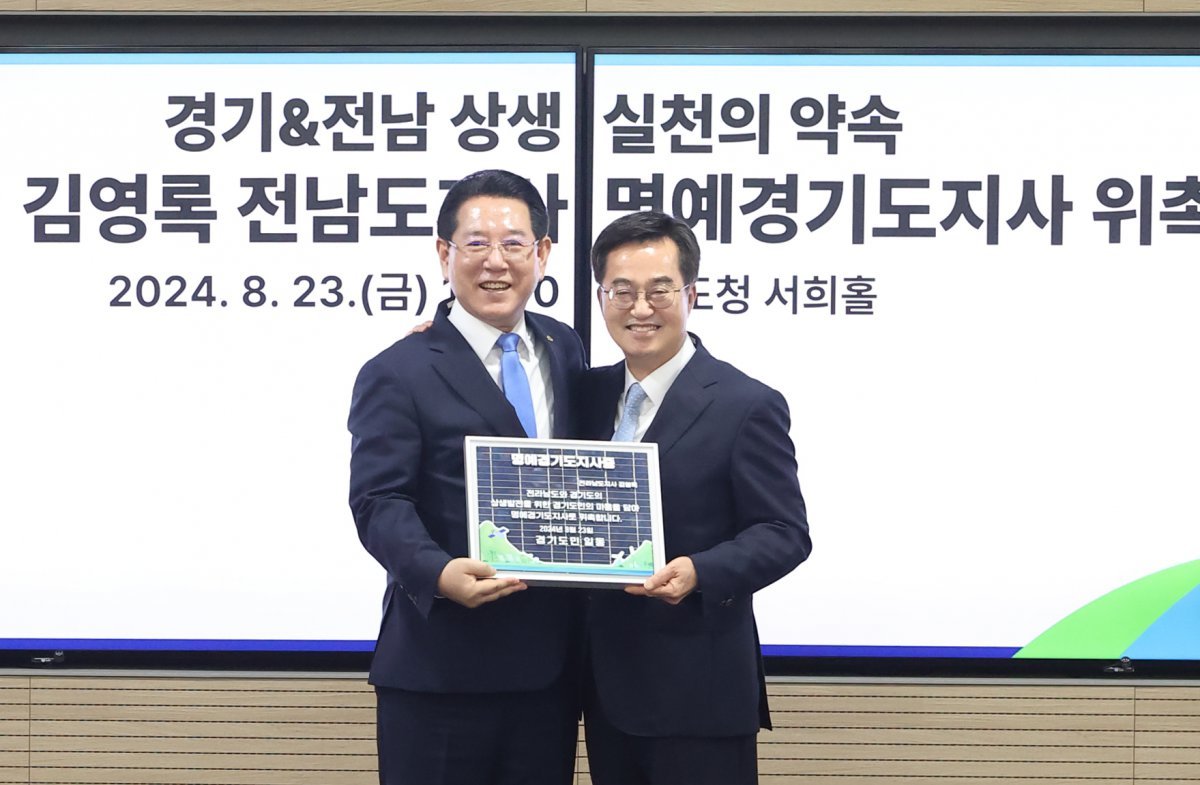 김동연 경기도지사가 23일 오전 경기도청 서희홀에서 김영록 전남도지사에게 1일 ‘명예경기도지사증’을 전달한 뒤 기념 촬영을 하고 있다. 경기도 제공