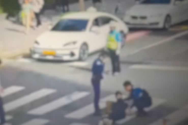 서울 강남구 횡단보도에 쓰러져 있는 여성을 경찰이 일으키고 있다. 유튜브 채널 ‘서울경찰’ 영상 캡처