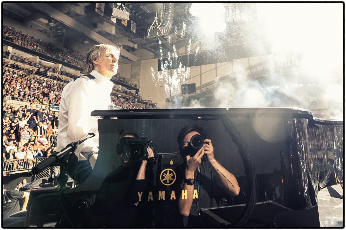 Photographer Kim Myung-joong takes a photo of Paul McCartney, a member of the legendary British band The Beatles, playing the piano during one of his concerts. The person reflected in the piano on the right is Mr. Kim. Courtesy of photographer Kim Myung-joong.