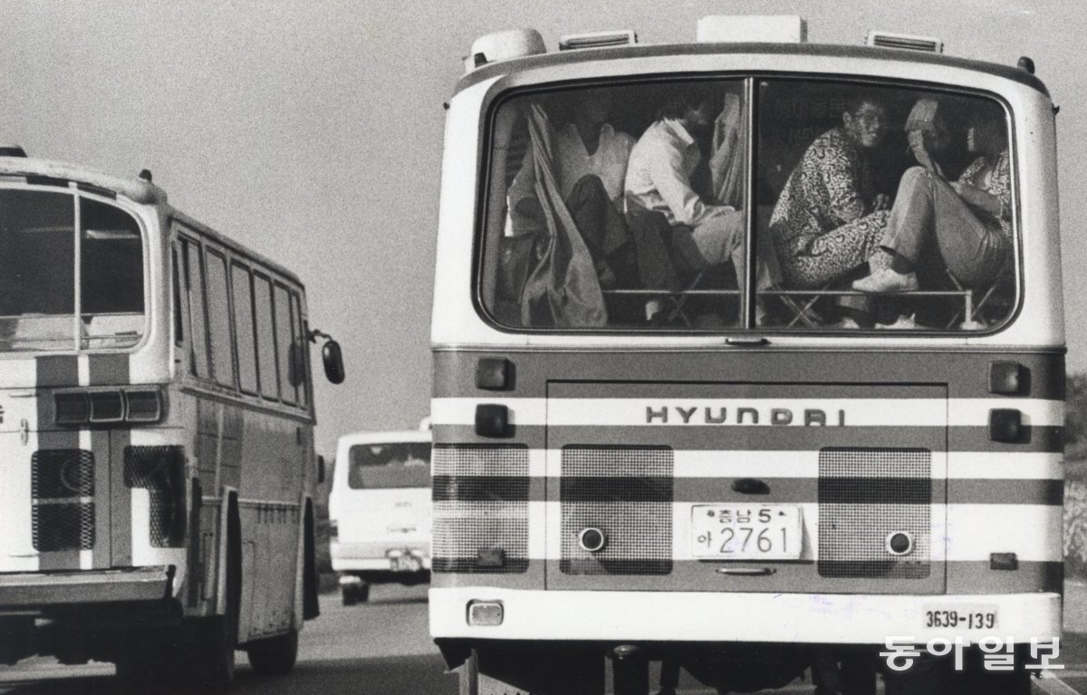 Is it luggage… or people…? The homecoming bus is also crowded. On the last day of the holiday, the 3rd, people who got on the bus like luggage experienced great inconvenience due to the large number of people who came home at once. A passenger is sitting in the luggage loading area of ​​a tour bus. 1982. 10. 04. Dong-A Ilbo DB