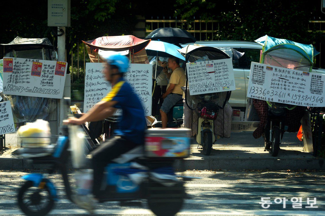 Last August, electric scooters with signs explaining rental fees were lined up on the roadside in Hangzhou, China. AP Newsis