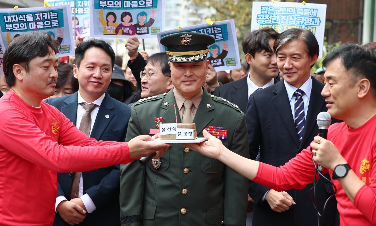 채 해병 순직사건 수사 이첩 관련 항명 및 상관명예훼손 혐의로 기소된 박정훈 전 해병대 수사단장(대령)이 21일 서울 용산구 중앙지역군사법원에서 열린 10차 공판에 앞서 가진 기자회견에서 해병대 동기로 부터 생일 축하 선물을 받고 있다. 2024.11.21/뉴스1 ⓒ News1