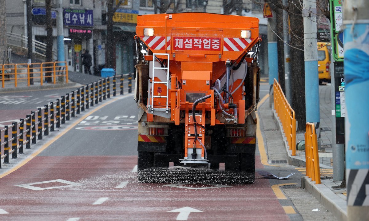 눈이 내리는 19일 서울 강북구 수유동 거리에서 제설차가 염화칼슘을 뿌리고 있다. 2023.12.19. 뉴시스