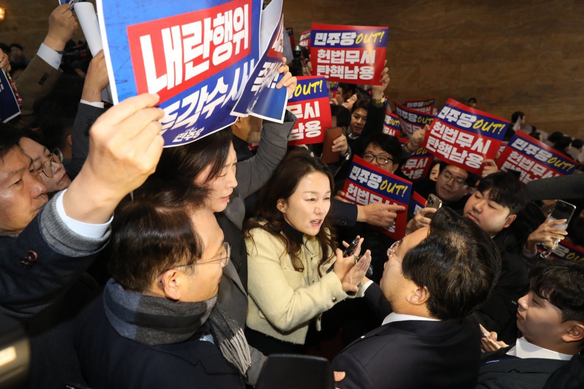 더불어민주당 이재정 의원(가운데 여성) 등 야당 의원들이 5일 오전 국회 본회의장으로 향하던 중 야당의 감사원장과 검사 탄핵 중단을 촉구하는 국민의힘 의원과 보좌진을 향해 거세게 항의하고 있다. 뉴스1