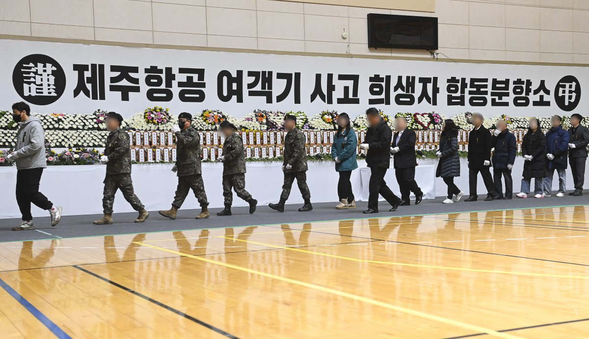 30일 전남 무안군 무안종합스포츠파크에 마련된 제주항공 여객기 사고 희생자 합동분향소에서 조문객들이 헌화하고 있다. 공동취재