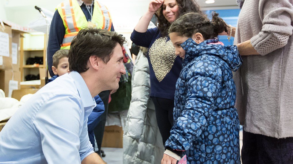 Prime Minister Trudeau welcoming Syrian refugees who arrived in Canada in 2015. This is one of the scenes that greatly raised his image around the world. Source: Office of the Prime Minister of Canada