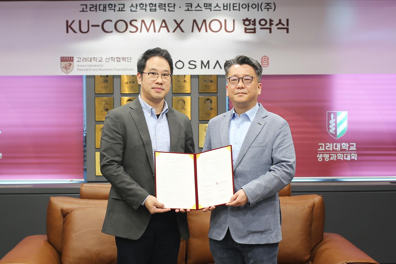 지난 6일 서울 성북구 고려대학교에서 열린 업무협약식에서 이동걸 코스맥스비티아이 MB랩장(왼쪽)과 이병천 고려대 산학협력단 부단장(오른쪽)이 기념 촬영을 하고 있다. 코스맥스 제공