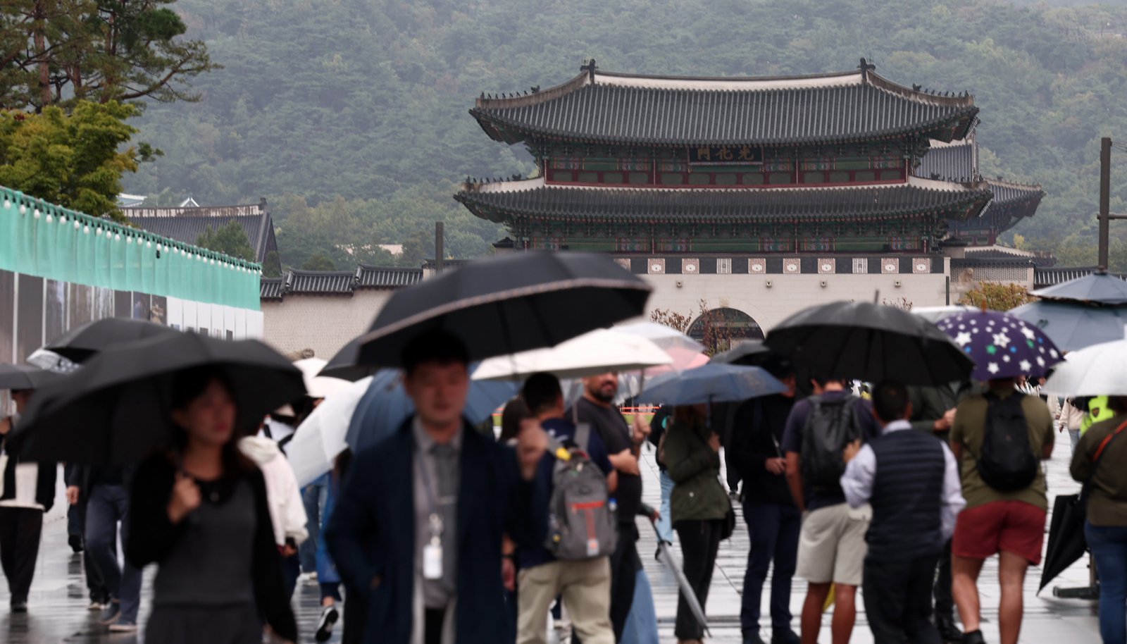 추석 연휴가 끝난 10일 서울 종로구 광화문광장에서 시민들이 우산을 쓴 채 발걸음을 옮기고 있다. 2025.10.10/뉴스1