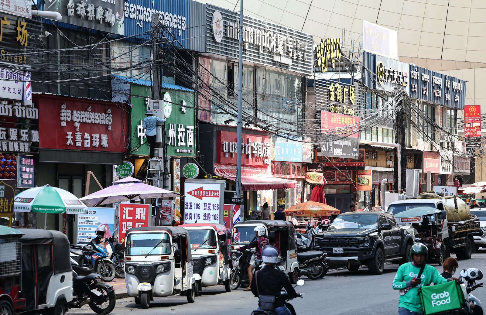 19일(현지시간) 캄보디아 프놈펜 한 거리 상가에 중국어와 크메르어가 혼재된 간판들이 붙어 있다. 2025.10.19. 뉴스1
