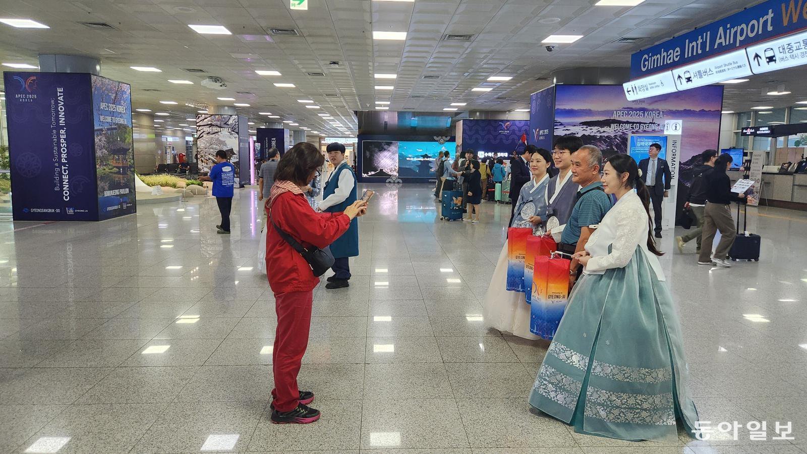 25일 부산 강서구 김해국제공항 국제선 청사 입국장에서 외국인 관광객이 한복을 입은 청년들과 기념사진을 찍고 있다. 부산=김화영 기자 run@donga.com