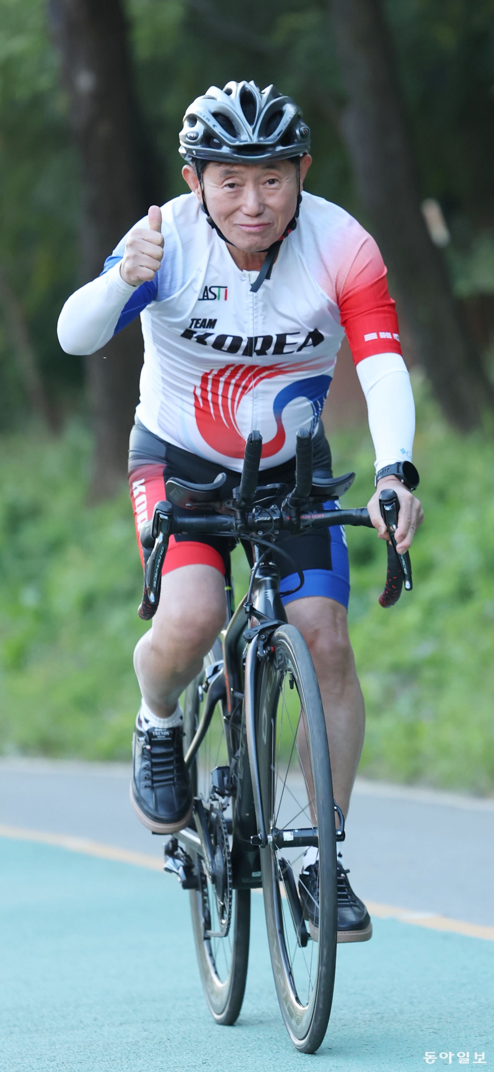 강준환 원장이 서울 강남 양재천에서 사이클을 타고 달리며 ‘엄지척’을 하고 있다.  신원건 기자 laputa@donga.com