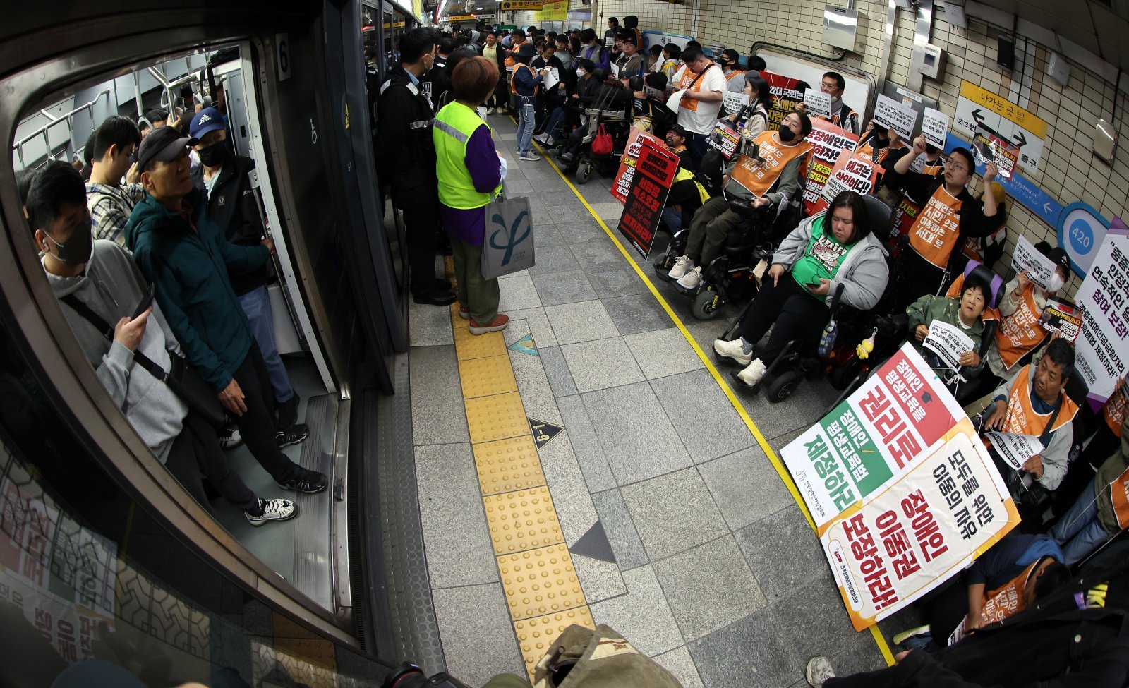 서울 지하철 4호선 혜화역 동대문 방면 승강장에서 열린 제62차 ‘출근길 지하철 탑니다’ 시위에서 전국장애인차별철폐연대(전장연) 회원들과 지하철 탑승 시민들이 마주보고 있다. 2025.4.21 뉴스1