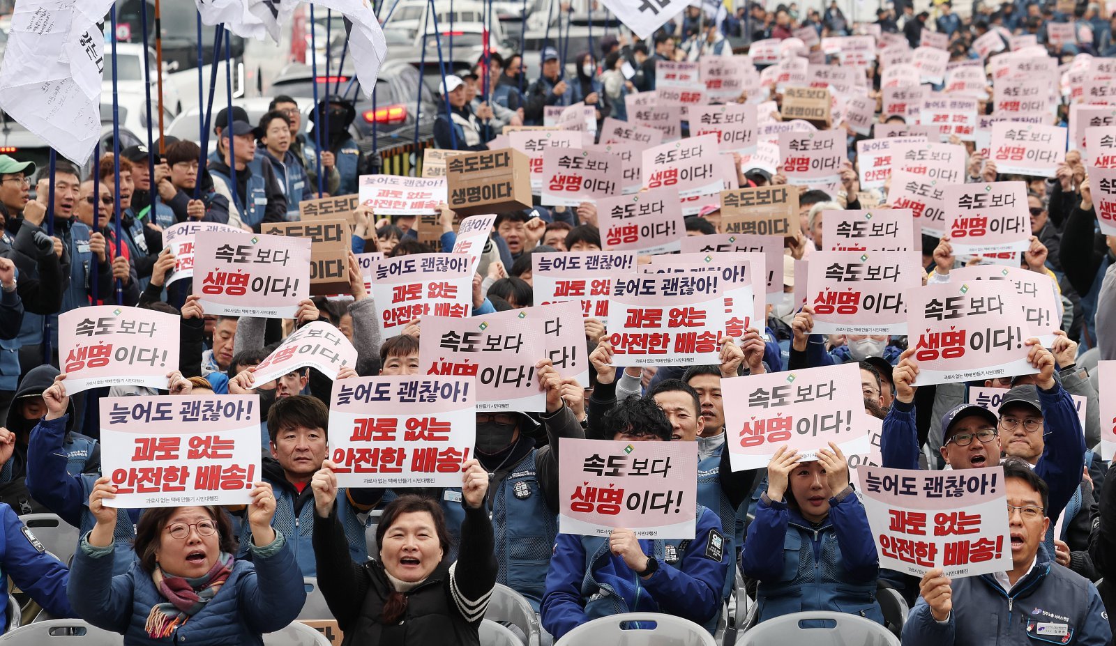 택배노동자들이 23일 서울 광화문 동십자각 앞에서 열린 ‘과로사 없는 택배 만들기 시민대행진’에 앞서 구호를 외치고 있다. 2025.11.23/뉴스1