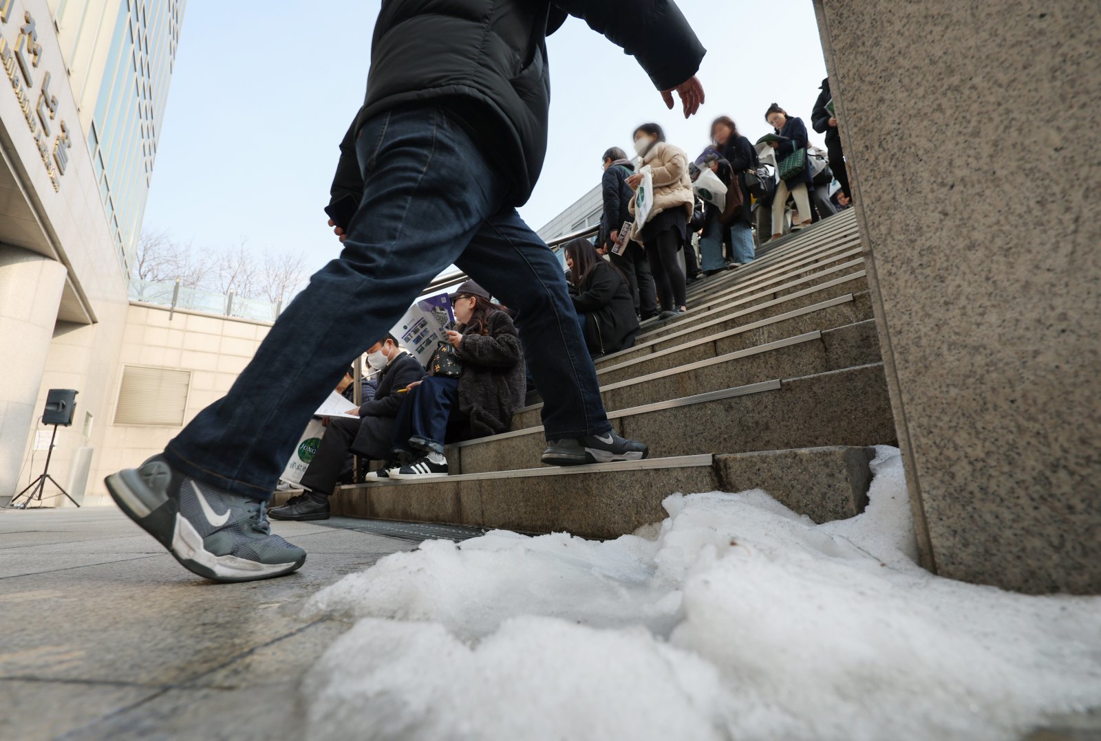 7일 서울 종로구 성균관대학교 600주년 기념관에서 열린 종로학원 주최 2026 정시 합격 가능선 예측 및 지원전략 설명회에 들어가지 못한 참석자들이 야외 계단에 앉아 설명회를 듣고 있다. 2025.12.07 뉴시스