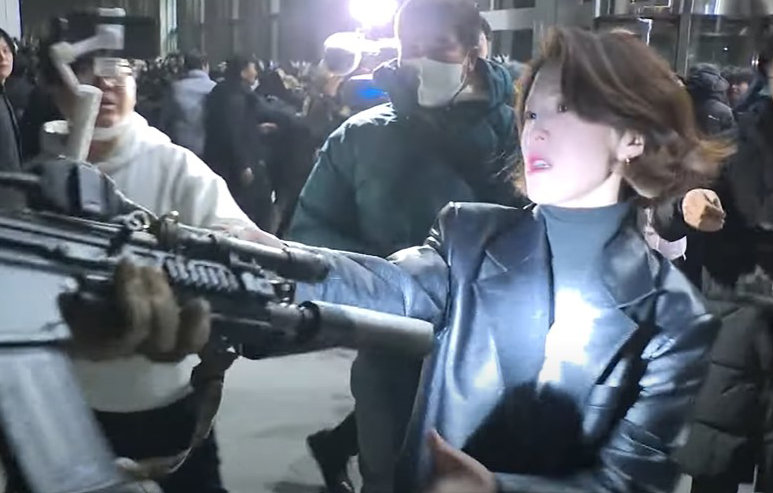 안귀령 대통령실 부대변인이 지난해 12·3 비상계엄 당시 국회의사당에서 계엄군의 총구를 붙잡고 실랑이를 벌이던 모습. 뉴시스