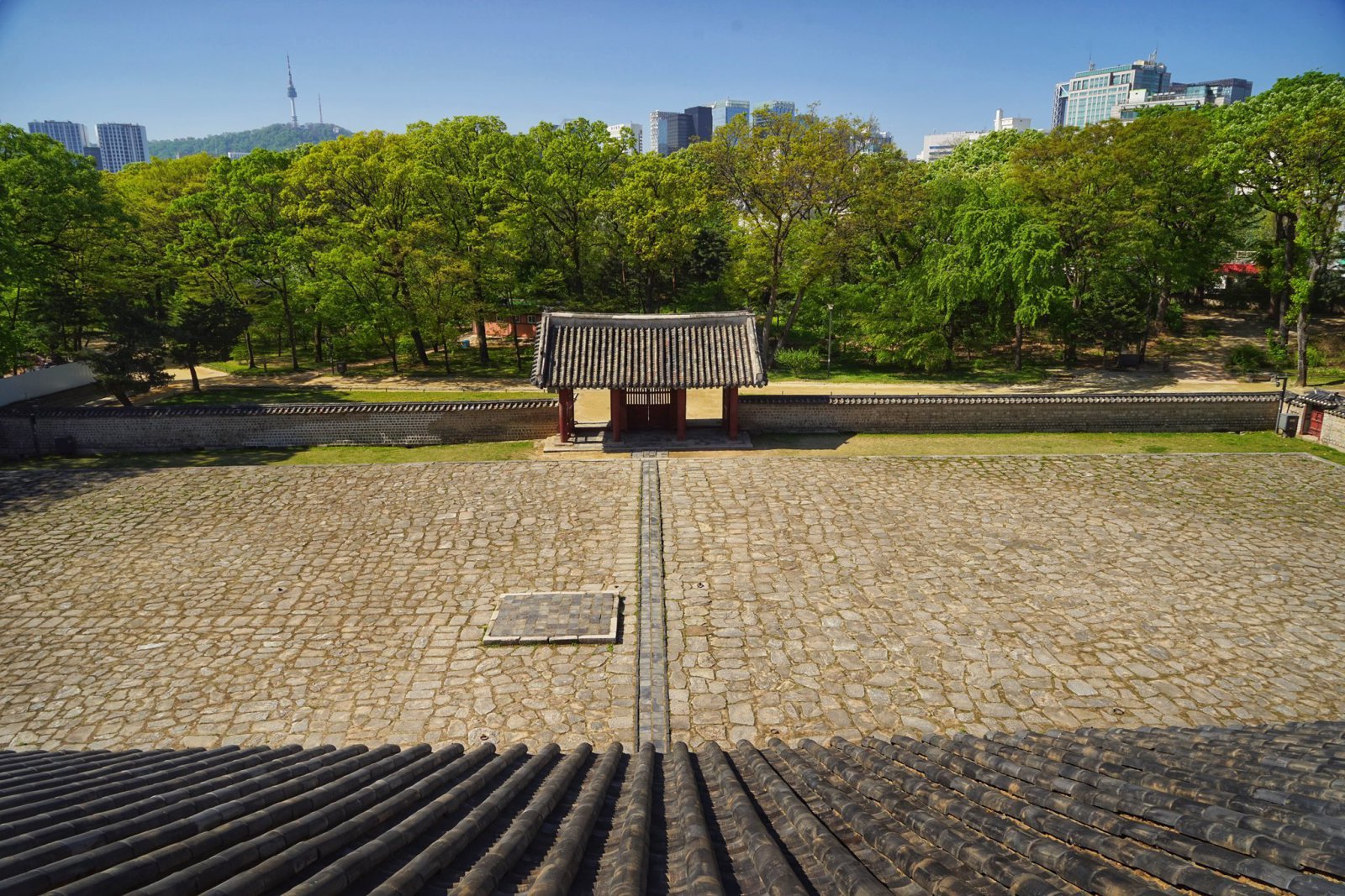 17년간 종묘의 보수를 맡아 온 정명식 대목수 겸 사진작가가 종묘 영녕전 지붕 위에서 도심을 촬영한 사진. 멀리 왼쪽에 남산의 능선이 보인다. 정명식 대목수 제공