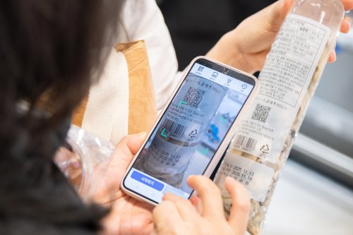 지난달 서울 용산구 이마트 용산점에서 열린 수산물이력제 홍보 행사에서 한 고객이 QR코드를 이용해 체험해 보고 있다.