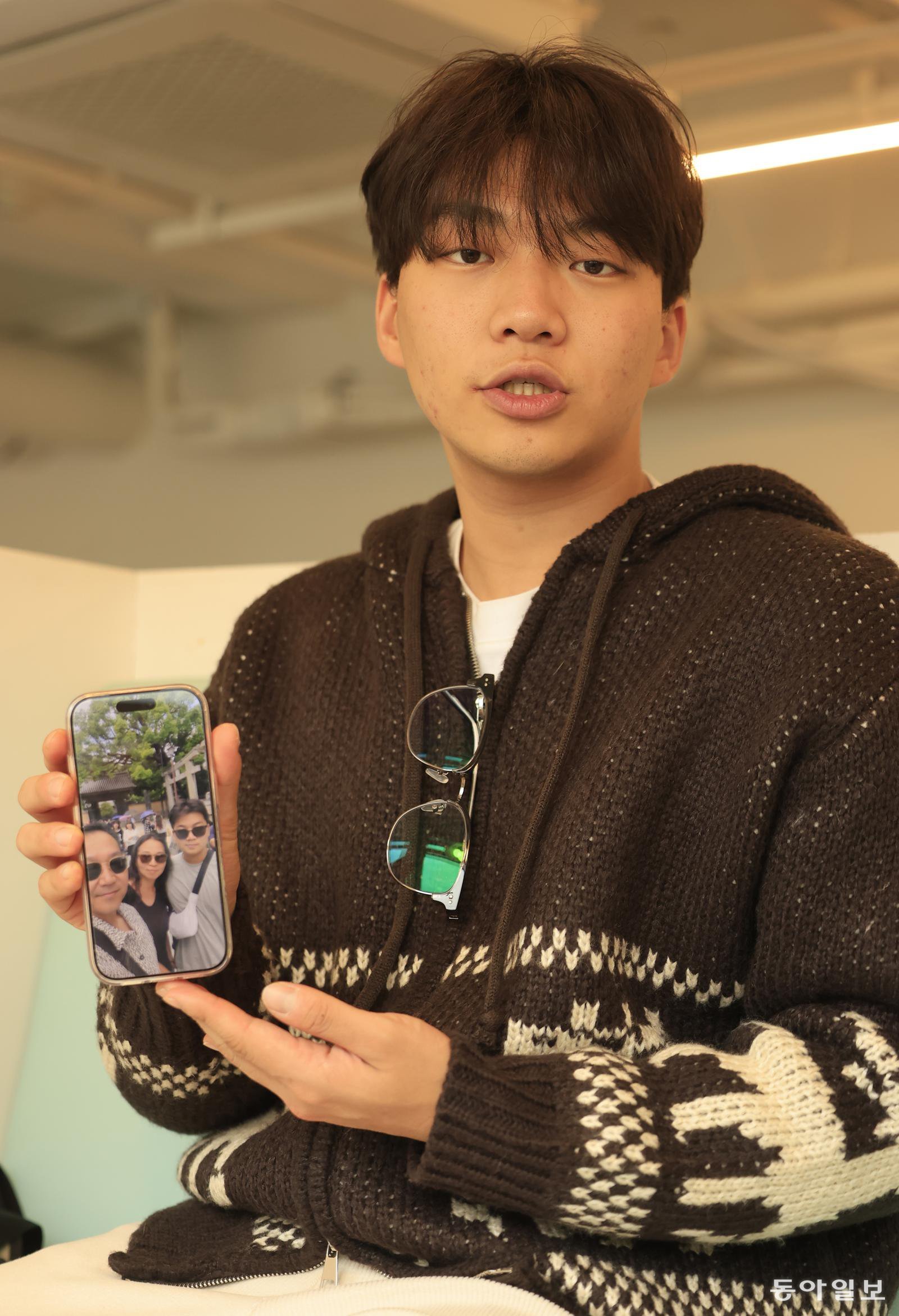 23일 오후 광주 동구 전일빌딩의 한 카페에서 박근우 씨가 가족과 함께 찍은 사진을 보여주고 있다. 광주=박영철 기자 skyblue@donga.com