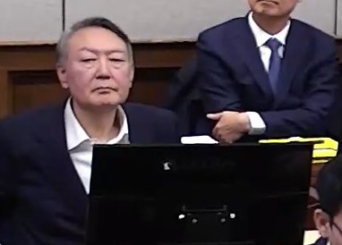 윤석열 전 대통령이 9일 서울 서초구 서울중앙지방법원에서 열린 내란 우두머리 혐의 1심 결심 공판에 출석해 자리에 앉아 있다. 2026.1.9. 서울중앙지방법원 제공 영상 캡쳐