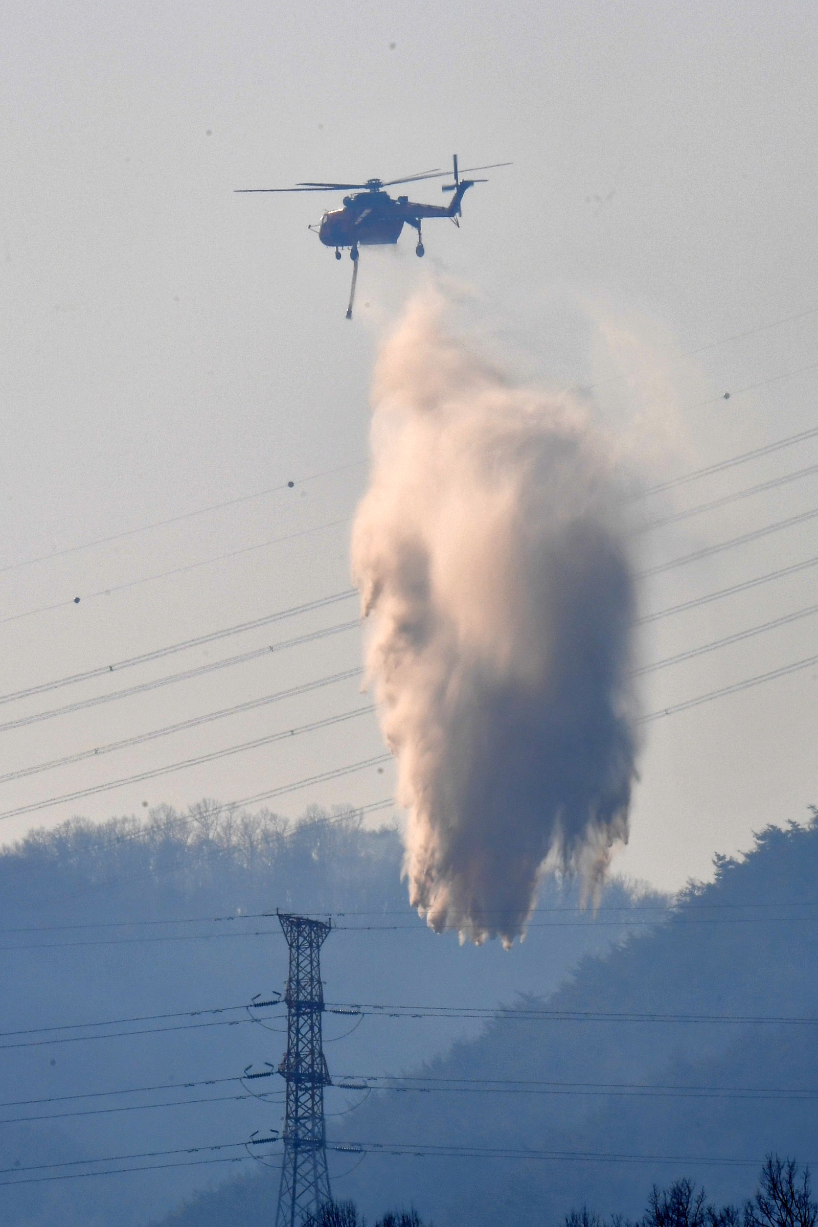 8일 오후 경북 경주시 문무대왕면 입천리 산불이 강풍을 타고 확산되는 가운데 산림청 초대형 핼기(S-64)가 송전선로 위에서 물을 투하하고 있다. 문무대왕면 산불에 대해 정부는 이날 오후 국가소방동원령을 발령했다.2026.2.8. 뉴스1