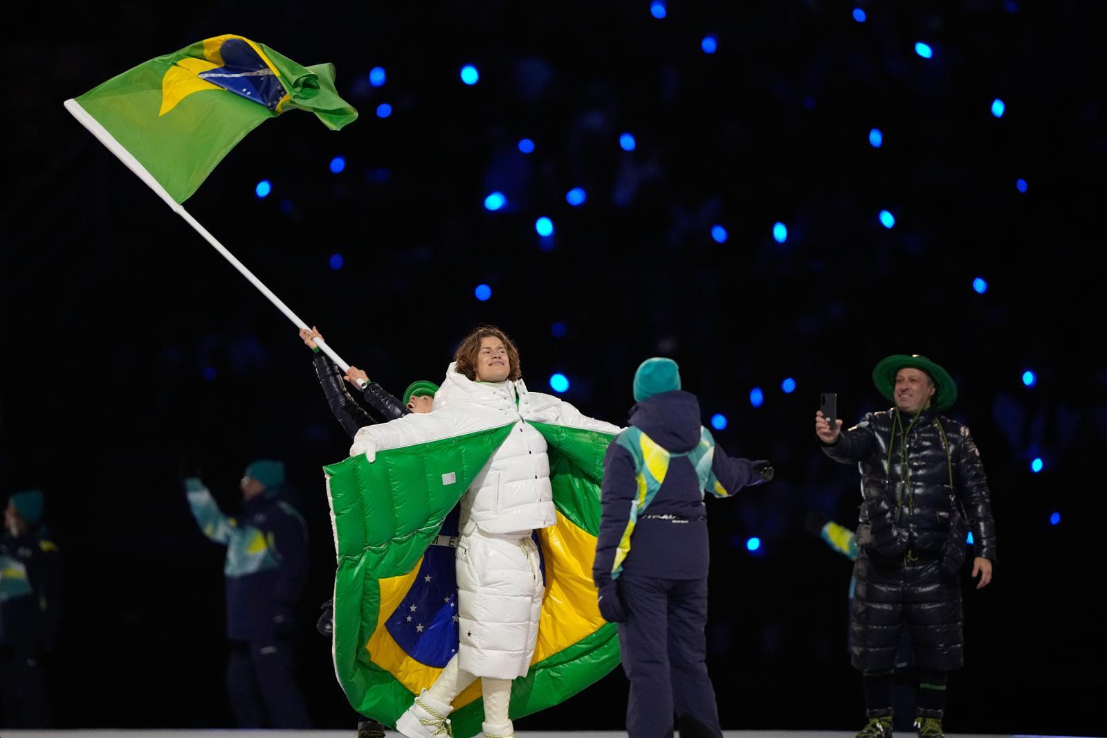브라질의 알파인 스키 선수 루카스 피네이루 브라텐이 개막식에서 안쪽에 브라질 국기가 새겨진 몽클레어 패딩을 휘두르고 있다. 밀라노=AP 뉴시스