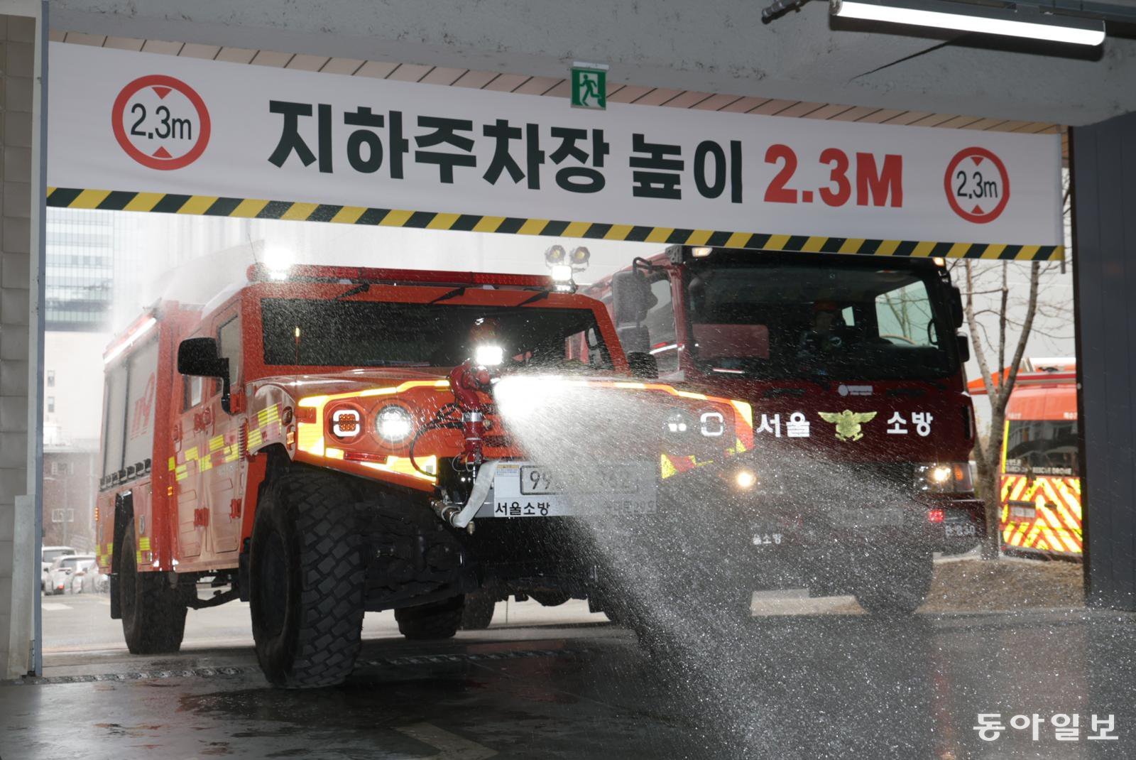 26일 서울 은평구 서울소방학교에서 열린 ‘미래형 재난 대응 체계 시연’ 행사에서 군용 소형 전술차량을 개조한 저상형 소방차가 물을 뿌리며 지하 주차장 내부로 들어가는 시범을 보이고 있다. 박형기 기자 oneshot@donga.com