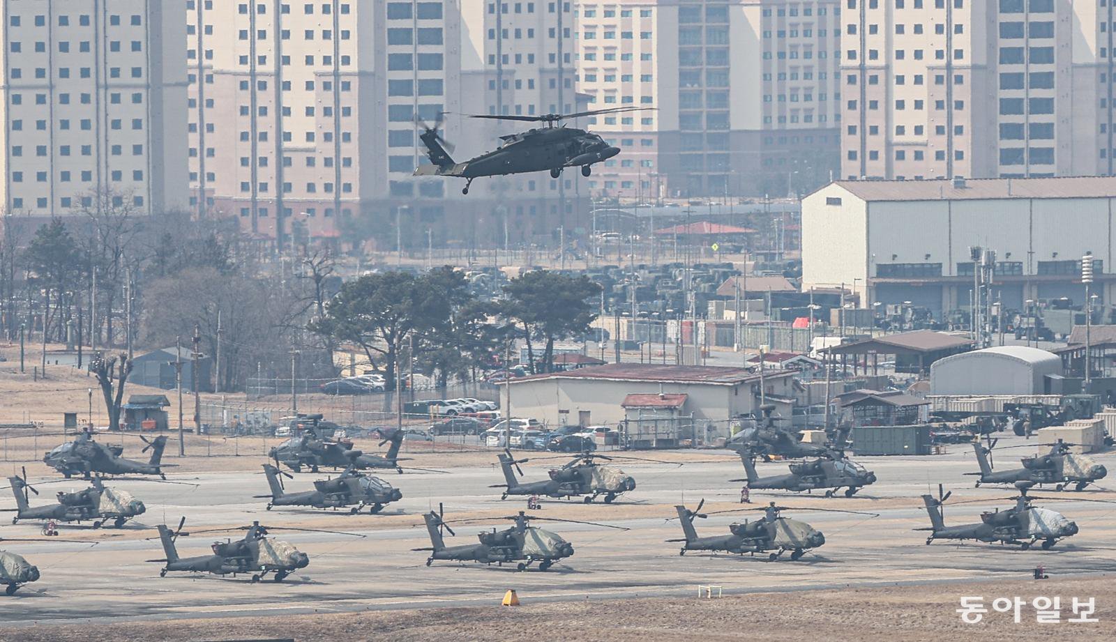 9일 경기 평택시 캠프 험프리스에서 UH-60 블랙호크 헬기가 비행하고 있다. 아래로는 아파치 헬기들이 계류돼 있다.  평택=이한결 기자 always@donga.com