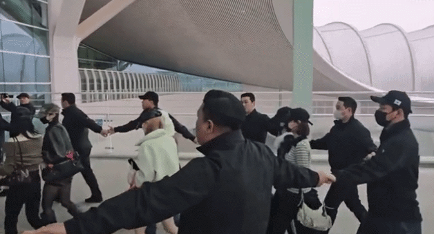 인천국제공항에서 경호 업체로부터 원형 띠 경호를 받는 그룹 하츠투하츠. 온라인 커뮤니티 보배드림 캡처