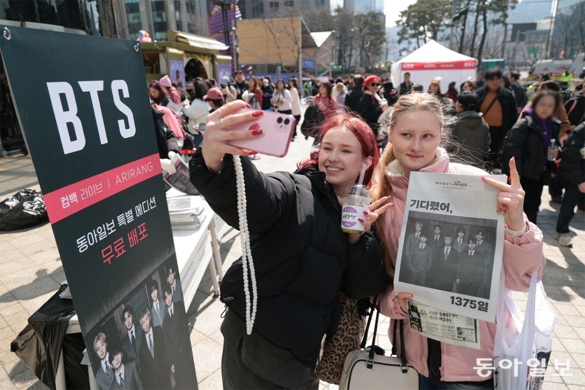 21일 서울 종로구 동아미디어센터 앞에서 BTS 팬들이 본보 BTS 특별판 신문을 들고 인증샷을 찍고 있다. 박형기 기자 oneshot@donga.com