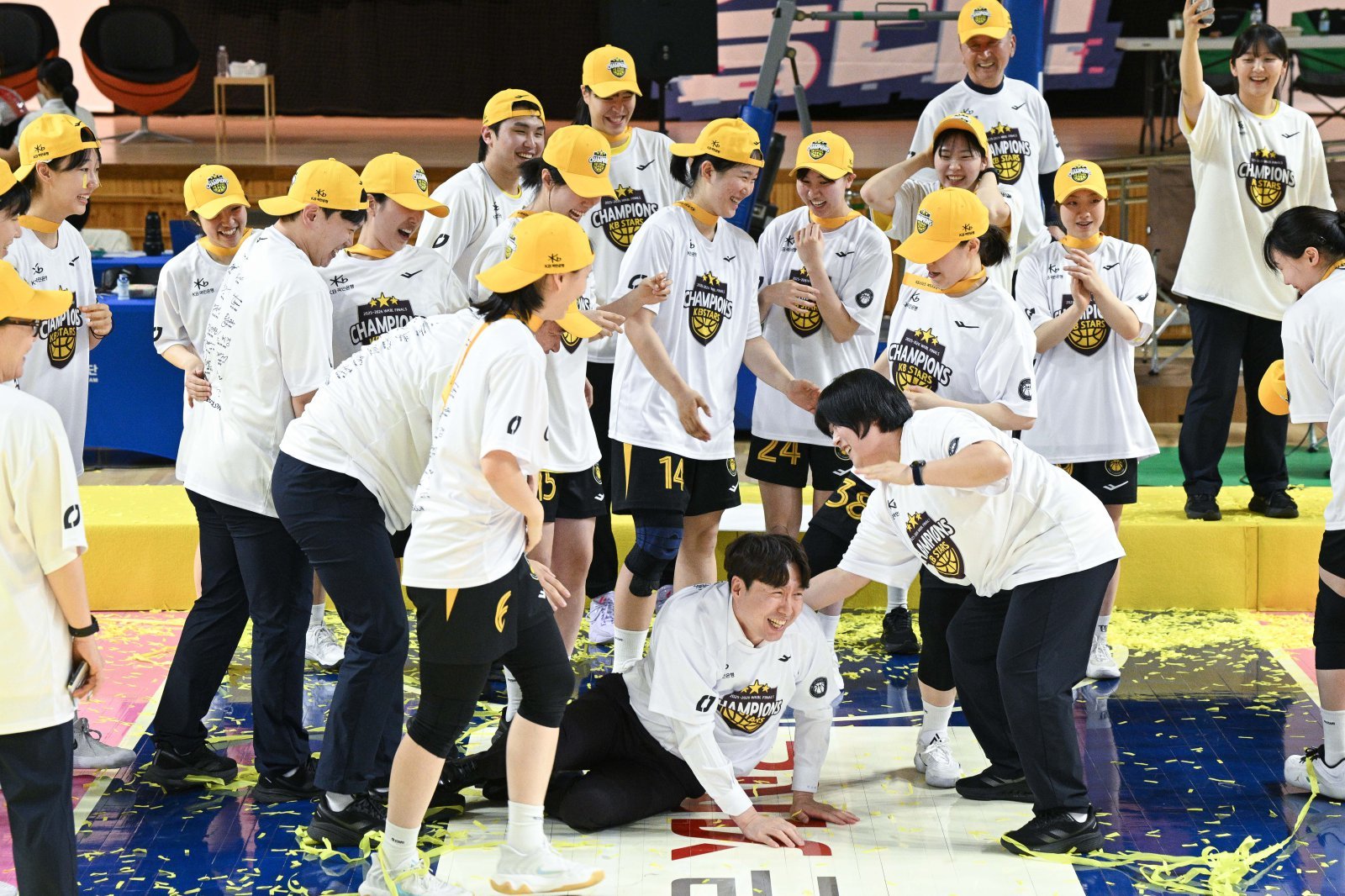 김완수 감독(가운데 쓰러진 사람)이 지난달 26일 2025~2026 시즌 WKBL 챔피언 결정전에서 우승한 뒤 KB스타즈 선수들로부터 격한 축하를 받으며 웃음 짓고 있다. WKBL 제공