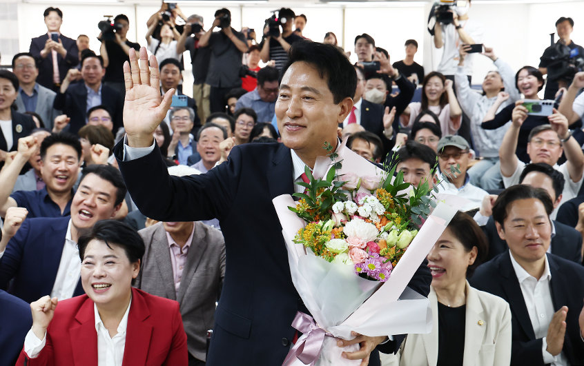 오세훈 국민의힘 서울시장 후보가 4일 서울 종로구에 마련된 본인의 선거사무소에서 당선이 유력해지자 입장 발표 후 꽃다발을 받고 환호 있다. 2026.6.4 뉴스1