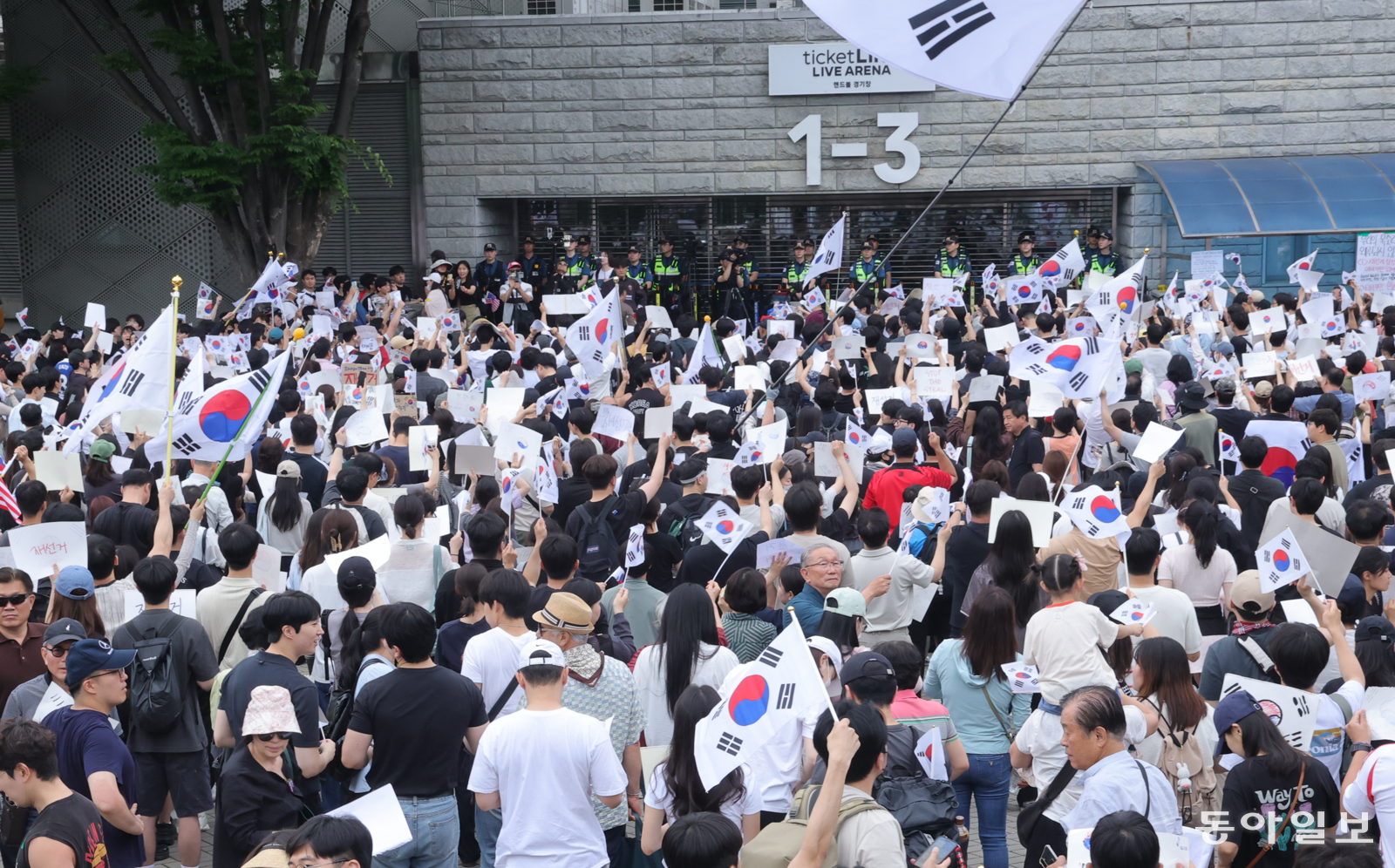 재선거 요구  6·3 지방선거 투표용지 부족 사태에 반발한 시민들이 7일 서울 송파구 올림픽공원 핸드볼경기장 개표소 앞에 모여 재선거를 요구하는 구호를 외치고 있다. 장승윤 기자 tomato99@donga.com