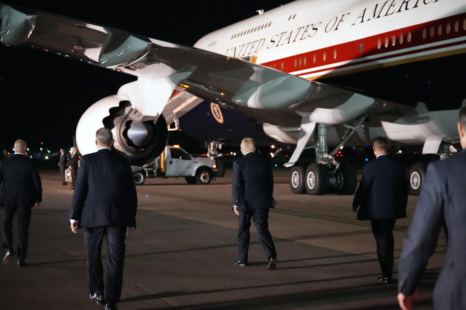 President Donald Trump, center, switches planes at U.S. Air Force Base, RAF Mildenhall in Suffolk Eastern England, on his way back to Washington from the NATO summit in Ankara, Turkey, Wednesday, July 8, 2026. (AP Photo/Alex Brandon)