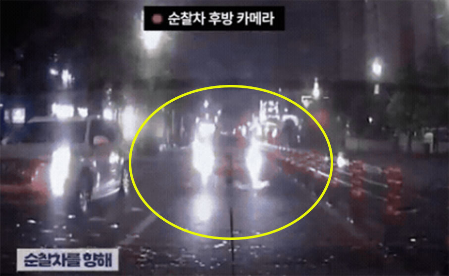 경찰차 바짝 붙어 상향등 ‘깜빡깜빡’…빗길 택시의 정체는