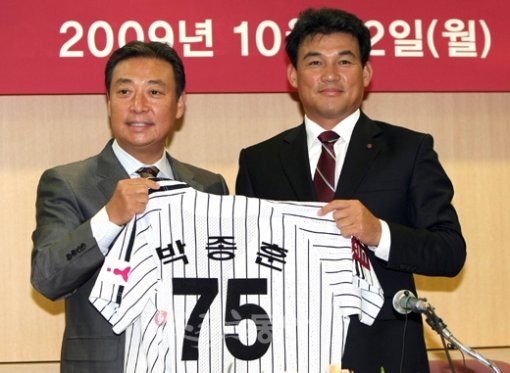 LG 박종훈(오른쪽) 신임 감독이 12일 열린 취임 기자회견에 앞서 LG스포츠 안성덕 사장으로부터 유니폼을 전달받고 있다. 박 감독은 5년 이내에 팀을 우승을 시키겠다는 포부를 밝혔다. 잠실 ｜ 김종원 기자 won@donga.com