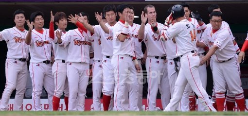 SK 최정(오른쪽 2번째)이 9일 문학 넥센전 3회 중월2점아치로 자신의 한 시즌 최다 홈런(21개)을 기록한 뒤 덕아웃으로 돌아와 동료들의 환영을 받고 있다. 문학|김종원 기자 won@donga.com 트위터 @beanjjun