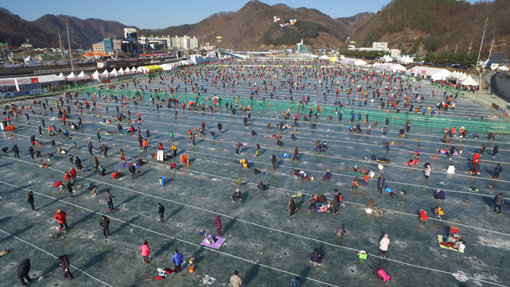 추위를 아랑곳하지 않고 꽁꽁 언 얼음 위에서 산천어 낚시에 여념이 없는 ‘화천 산천어 축제’의 방문객들. 외국인 관광객들이 즐겨 찾는 명소로 자리매김한 화천 산천어 축제는 오는 31일까지 열린다. 사진제공｜화천군청