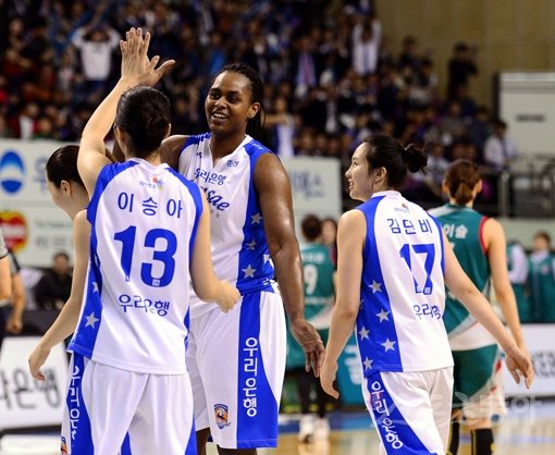 우리은행 사샤 굿렛(왼쪽 두번째)이 16일 춘천 호반체육관에서 벌어진 ‘KDB생명 2015~2016 여자프로농구’ 챔피언 결정전 1차전 KEB하나은행과의 홈경기 도중 득점에 성공한 뒤 이승아와 하이파이브를 나누고 있다. 굿렛은 8점·7리바운드로 팀 승리에 기여했다. 춘천｜김종원 기자 won@donga.com