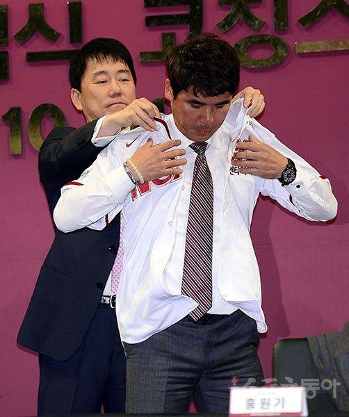 넥센 이장석 구단주가 10월31일 고척스카이돔에서 열린 신임감독 취임식 및 코칭스태프 발표회에서 장정석 새 감독에게 유니폼을 입혀주고 있다. 고척 ｜ 김종원 기자 won@donga.com