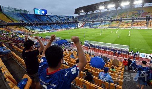 축구팬들이 2일 수원월드컵경기장에서 열린 K리그1 수원 삼성과 대구FC의 경기를 직접 보기 위해 비가 내리는 와중에도 경기장을 찾아 응원을 보내고 있다. K리그는 1일부터 전체 좌석의 10% 규모로 관중 입장이 허용됐다. 수원｜김민성 marineboy@donga.com