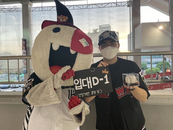 KT 열혈팬인 엄기우씨(오른쪽)가 13일 수원KT위즈파크에서 또리와 함께 사진촬영을 하고 있다. 엄 씨는 군 입대를 하루 앞두고 수원 홈구장을 찾아 열정적인 응원을 보냈다. KT는 엄 씨에게 밀리터리 모자와 소형준, 강백호의 사인볼을 선물했다. 사진제공 | KT 위즈