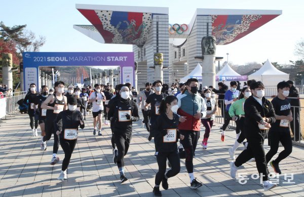 ‘2021 서울마라톤’이 28일 서울 올림픽공원 평화의 문을 출발해 잠실종합운동장으로 골인하는 42.195㎞의 풀코스에서 
펼쳐졌다. 이번 대회는 코로나19 이후 국내 마라톤대회로는 처음으로 개최된 ‘오프라인 레이스’였다. 출발 총성과 함께 평화의 문을
 뒤로 한 채 힘차게 레이스를 시작한 참가자들. 사진=동아일보