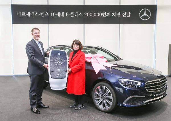 토마스 클라인 메르세데스-벤츠 코리아 대표이사 사장(왼쪽)이 20만 번째 10세대 E-클래스 차량을 고객에게 전달하며 기념 촬영하고 있다. 사진제공|메르세데스-벤츠 코리아