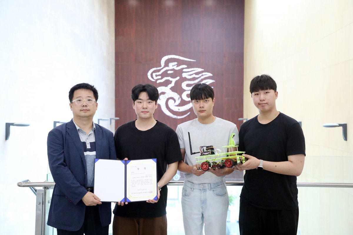 김희수 교수와 경진대회 참가 학생들(권호산 학생, 박진형 학생, 김용일 학생)이 상장과 자율주행 자동차를 들고 기념사진을 촬영하고 있다. 사진제공ㅣ영남이공대