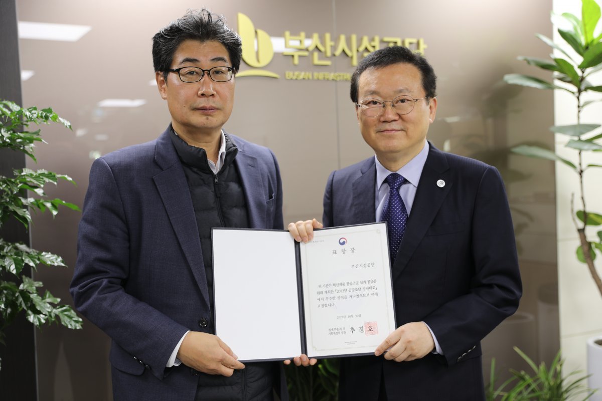 이성림 이사장(오른쪽)이 신종석 부산지방조달철장(왼쪽)으로부터 혁신대상 표창장을 전수받고 기념촬영을 하고 있다. 사진제공ㅣ부산시설공단