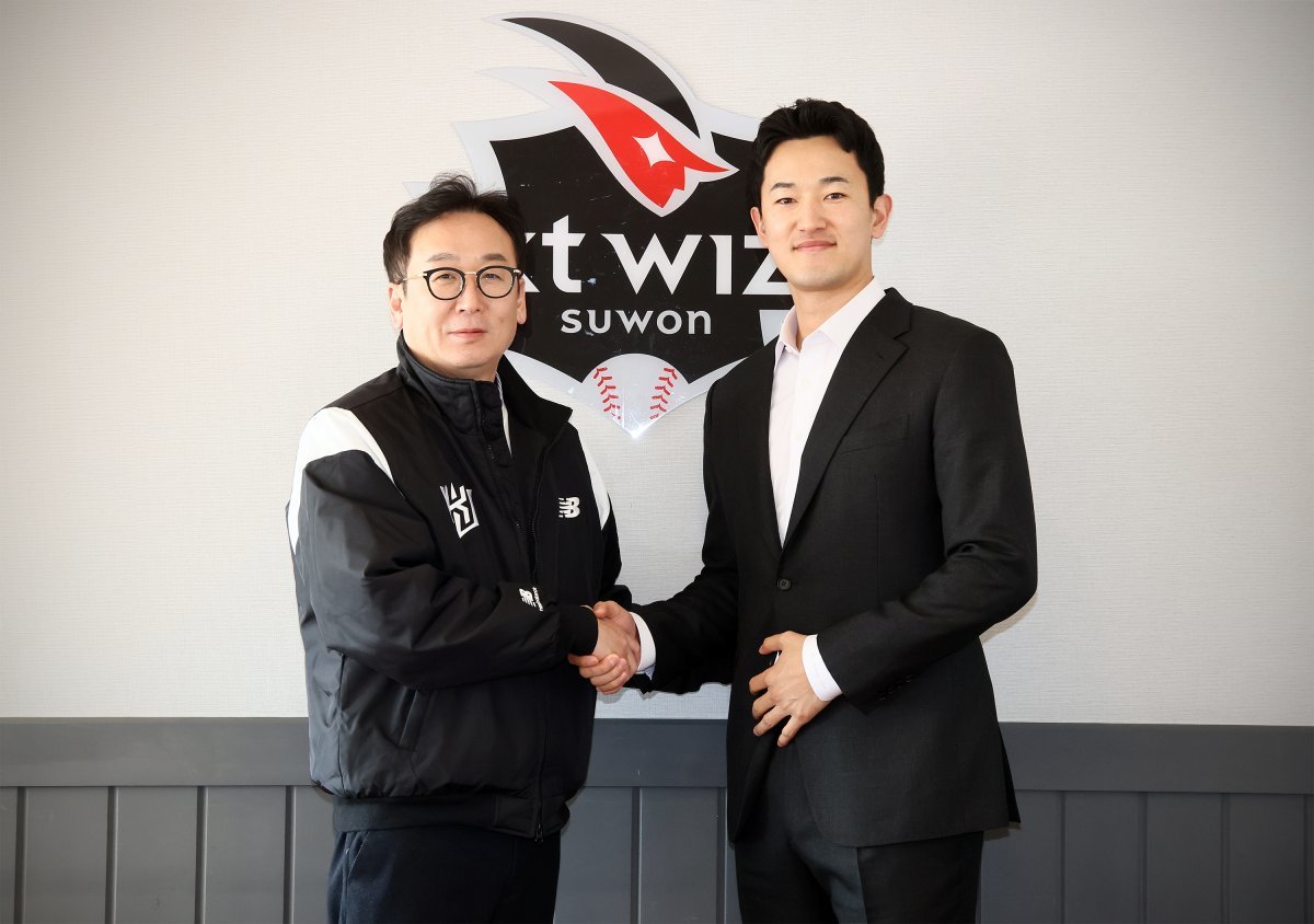 25일 수원KT위즈파크에서 KT와 구단 최초 비FA 다년계약을 맺고 나도현 단장과 기념사진을 찍는 고영표. 사진제공 | KT 위즈