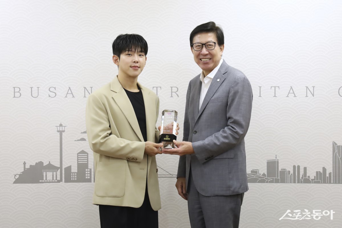 부산시가 지난 9일 ‘커피도시 부산’을 알릴 홍보대사로 가수 폴킴(왼쪽)을 위촉한 가운데 박형준 시장이 위촉패를 전달하고 있다. (사진제공=부산시)